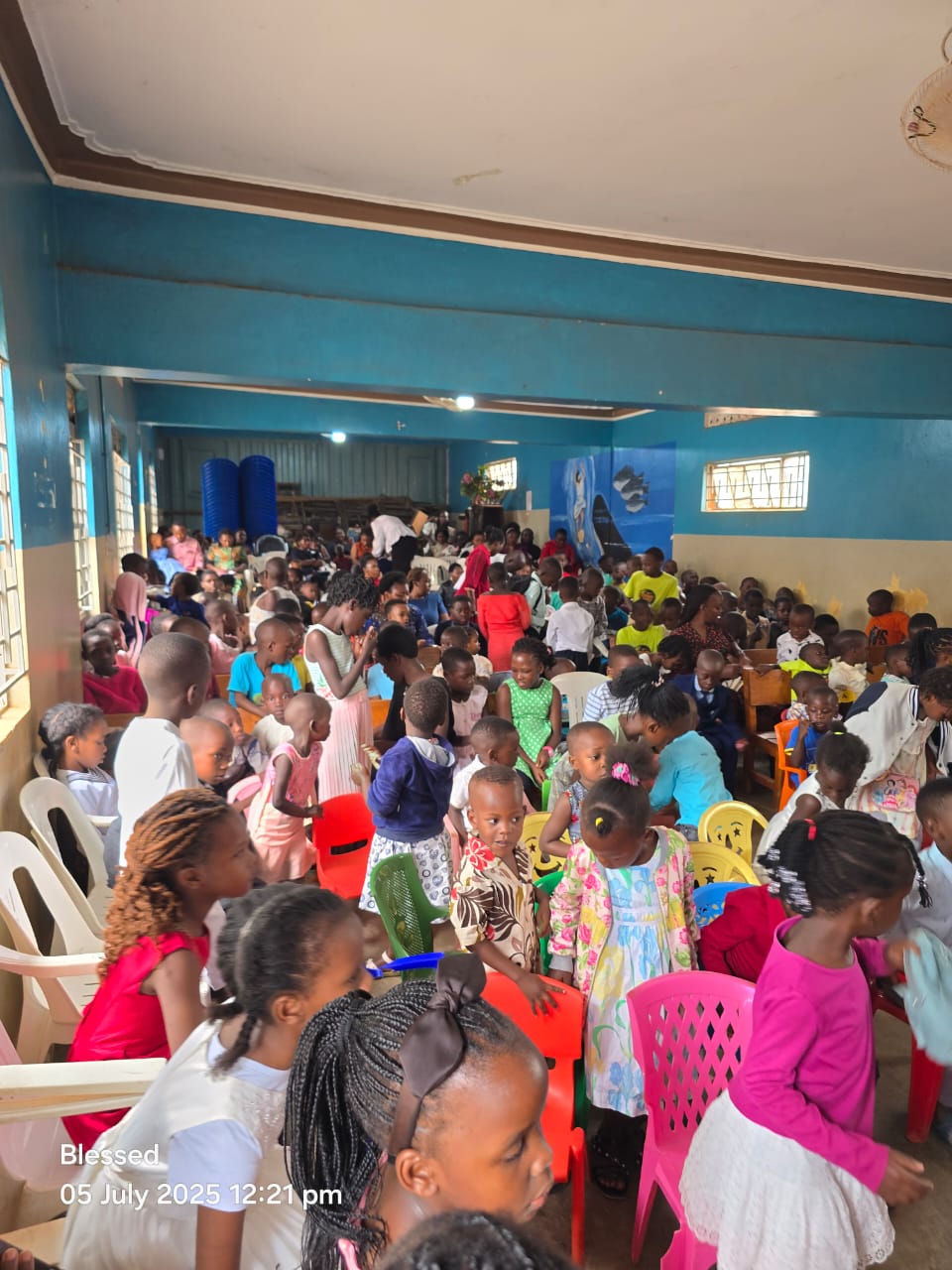 Hall filled with children and families on a community day