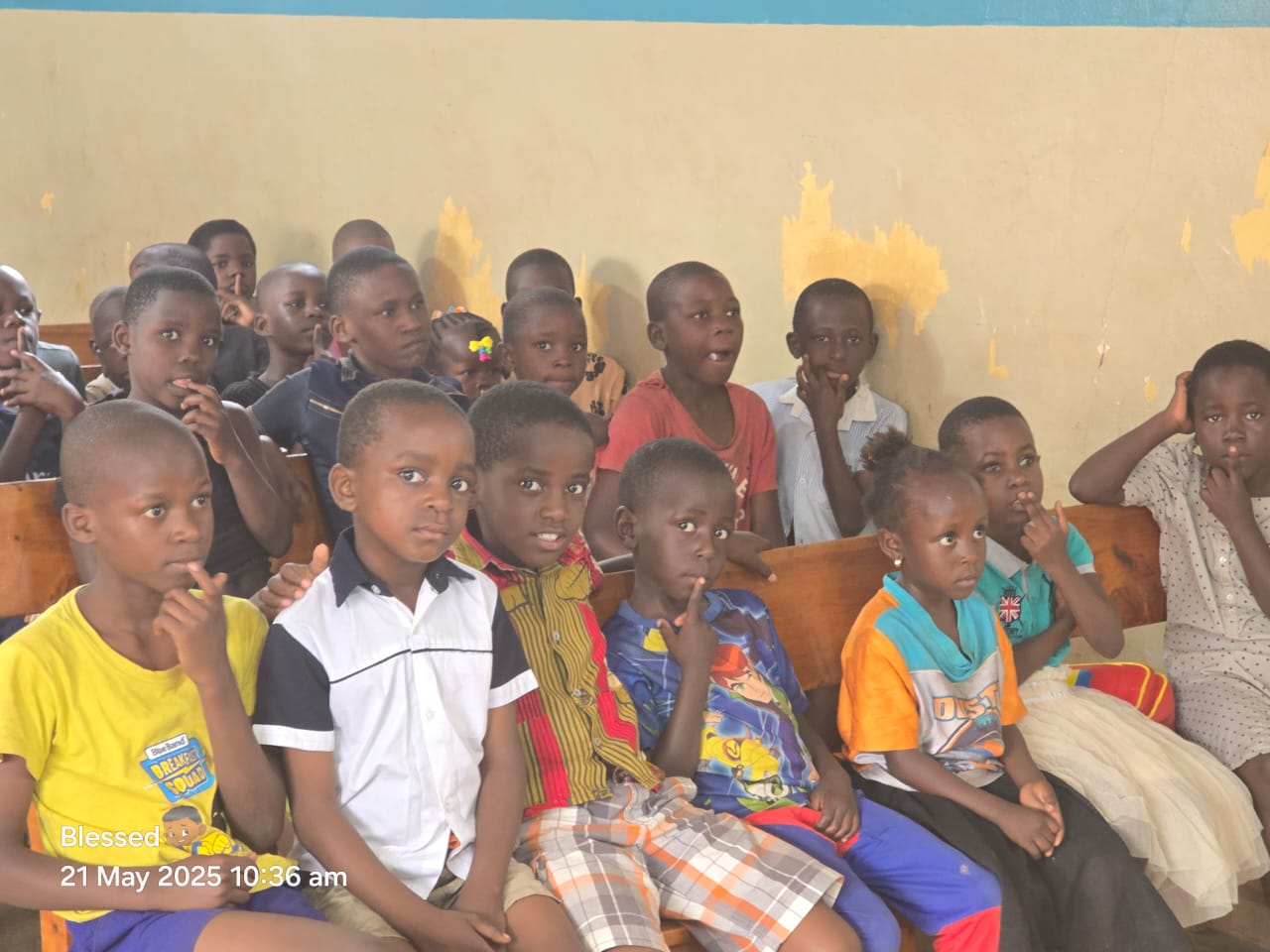 A row of children listening attentively