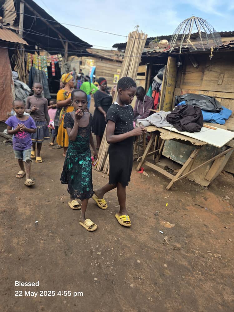 Two girls walking through the streets of Kivulu