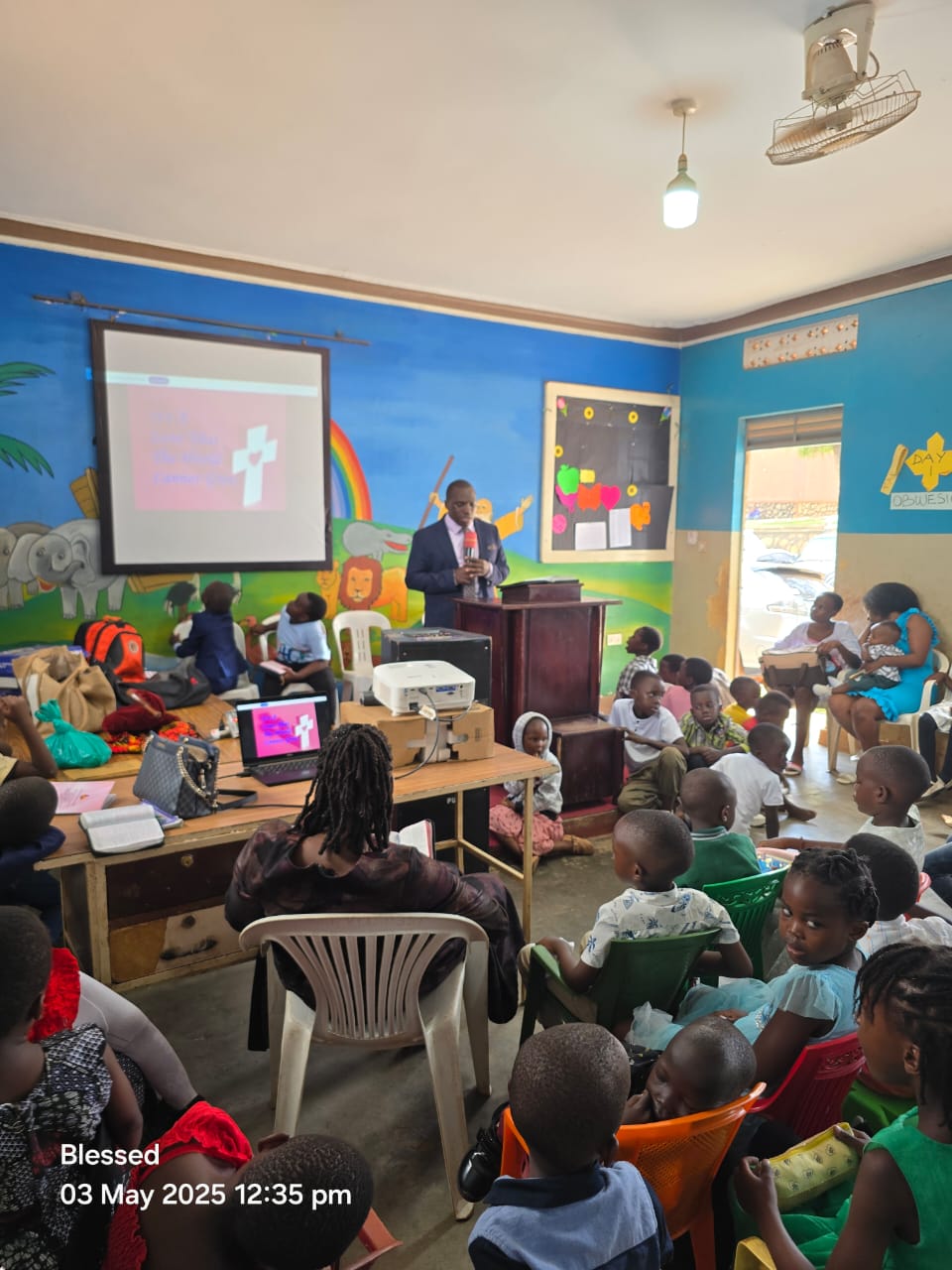 Pastor teaching children with a projector