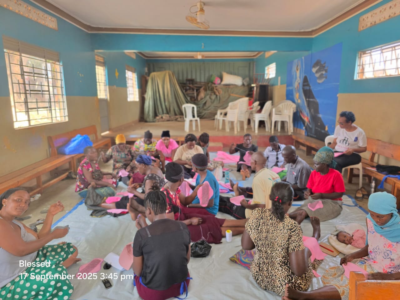 Mothers learning to sew reusable sanitary pads in a workshop