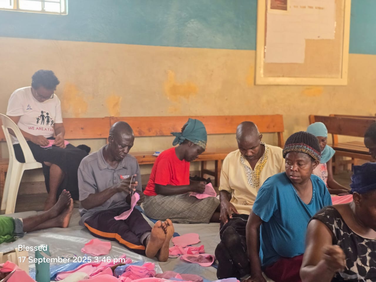Adults sewing reusable pads in a workshop